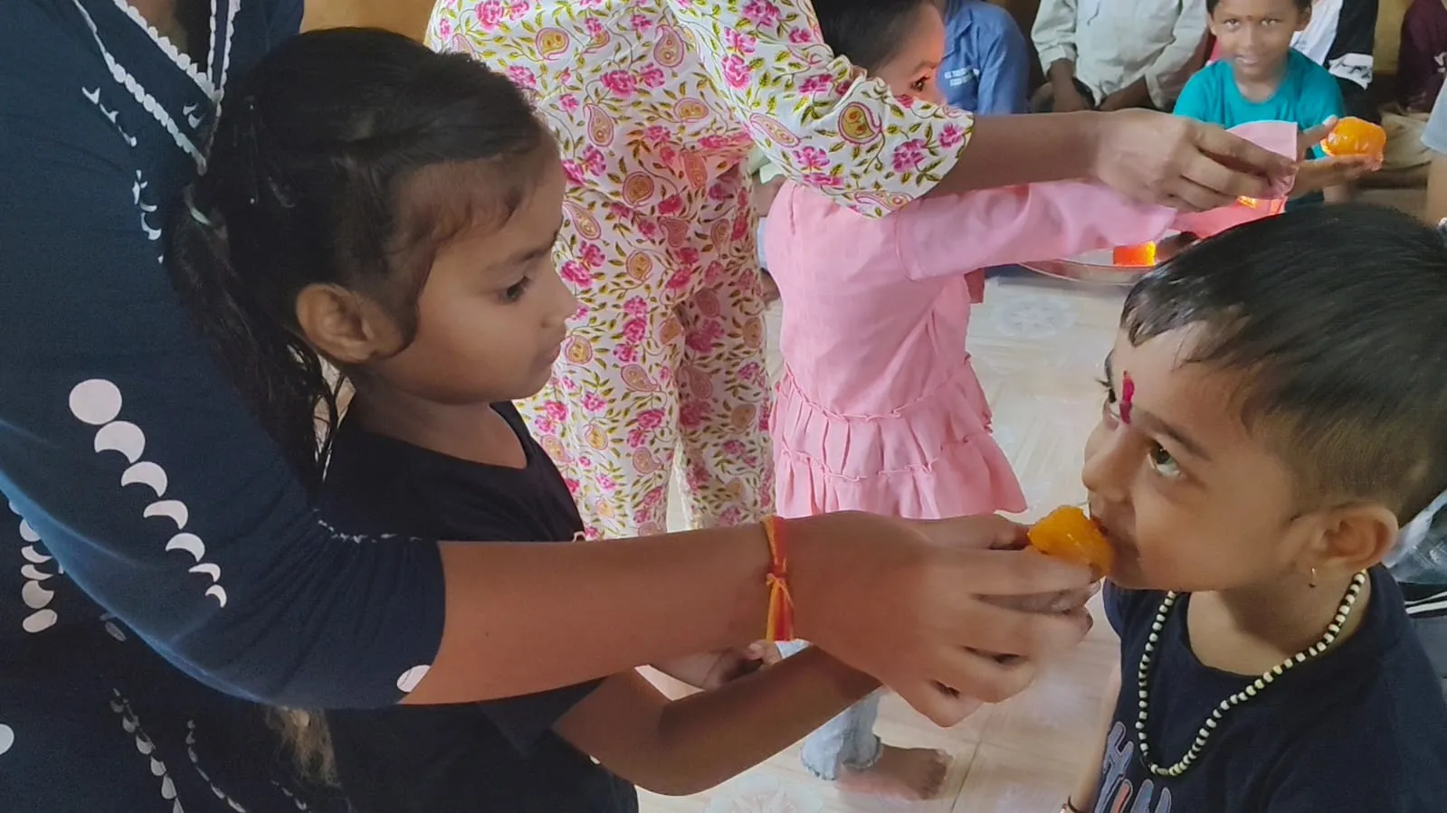 Children tying rakhi at Child Safe Foundation